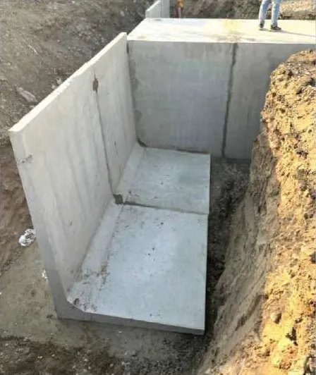 Precast L-shaped earth retaining wall units installed in an excavation
